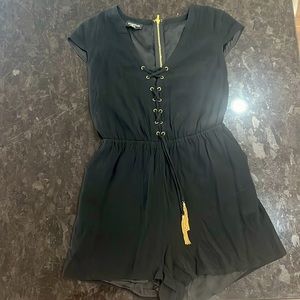 Bebe black romper with gold tassels